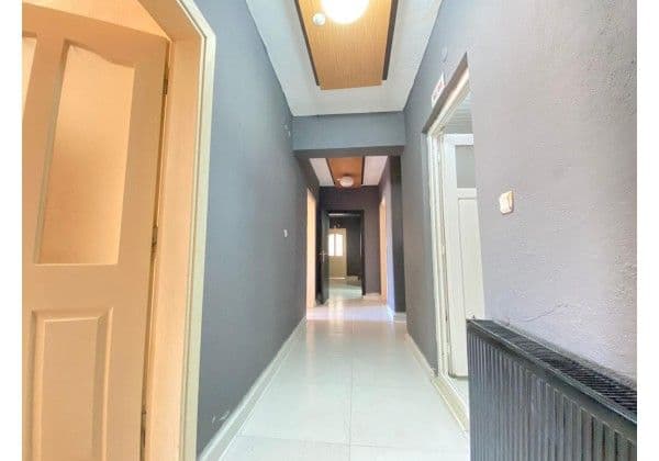 Yurt kat koridoru, oda kapıları ve merkezi ısıtma peteği